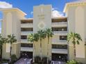 Majestic Point condos exterior featuring a neutral facade, tropical landscaping, and secure gated entrances at 200 Skiff Pt # 202, Clearwater Beach, FL 33767