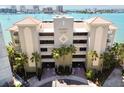 Majestic Point condos exterior featuring a neutral facade, tropical landscaping, and secure gated entrances at 200 Skiff Pt # 202, Clearwater Beach, FL 33767