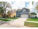 Inviting home featuring manicured lawn and a spacious driveway leading to a two-car garage at 2318 Kenwick Dr, Valrico, FL 33596