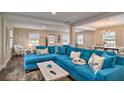 Bright living room featuring a large sectional sofa, windows, and hardwood floors at 284 North St, Palm Harbor, FL 34683
