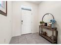 Bright foyer with tile flooring, console table, mirror, and decor at 2925 Evergreen Elm Pass, Wesley Chapel, FL 33543