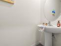 Stylish powder room featuring a pedestal sink and decorative accents at 2925 Evergreen Elm Pass, Wesley Chapel, FL 33543