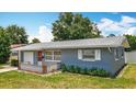 A charming single-story home with a manicured lawn, red front door, and patterned decorative accents at 3271 36Th N St, St Petersburg, FL 33713