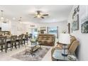 Bright and airy living room featuring stylish furnishings, a ceiling fan, and neutral decor at 36312 Garden Wall Way, Zephyrhills, FL 33541