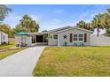 Charming single-story home featuring well-maintained landscaping, a long driveway, and cozy front porch at 512 Flame Tree Dr, Apollo Beach, FL 33572