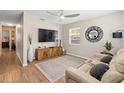 Comfortable living room with a modern ceiling fan, a large TV, and a cozy seating area at 512 Flame Tree Dr, Apollo Beach, FL 33572