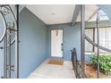 A covered entryway with blue walls and an ornate door at 5540 Applegate Dr, Spring Hill, FL 34606