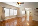 Spacious living room featuring polished hardwood floors, large windows, and arched doorway at 6419 S Englewood Ave, Tampa, FL 33611