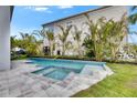 Backyard showcasing a modern pool and spa, surrounded by well-maintained landscaping at 6526 Simone Shores Cir, Apollo Beach, FL 33572