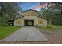 House exterior with a covered carport and long driveway, perfect for parking at 7189 Griffin Rd, Brooksville, FL 34601