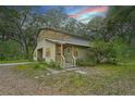Charming two-story home featuring a screened upper porch and inviting front entrance at 7189 Griffin Rd, Brooksville, FL 34601