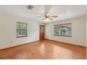 Bright living room with wood look floors, natural light, and a door leading to the outside at 7189 Griffin Rd, Brooksville, FL 34601