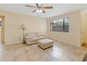 Well-lit living room boasts tile floors, a comfortable sofa, and a window for natural light and outdoor scenery at 8436 60Th N St # 304, Pinellas Park, FL 33781