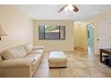 Bright living room features neutral tones, tile flooring, and a large window offering serene outdoor views at 8436 60Th N St # 304, Pinellas Park, FL 33781