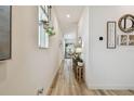 Bright hallway with wood-look flooring, neutral walls, and stylish decor accents at 9577 Sandy Bluffs Cir, Parrish, FL 34219