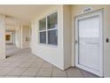 Condo hallway with tiled floors and neutral walls leading to unit 2405 at 960 Starkey Rd # 2405, Largo, FL 33771