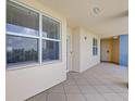 View of a hallway with a tile floor leading to the entrance of a condo at 960 Starkey Rd # 2405, Largo, FL 33771