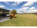 Large backyard features an enclosed porch area, lush lawn, and plenty of space for outdoor enjoyment at 9814 Palazzo St, Seffner, FL 33584