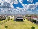 Expansive backyard with green lawn and fenced perimeter, perfect for outdoor activities and privacy at 9814 Palazzo St, Seffner, FL 33584