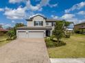 Charming home with a well-maintained lawn, brick-paved driveway, and a welcoming two-car garage at 9814 Palazzo St, Seffner, FL 33584
