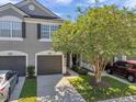 Inviting two-story townhome with two-car garage, pretty landscaping, and a welcoming front entry at 10217 Westpark Preserve Blvd, Tampa, FL 33625