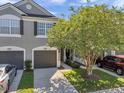Well maintained townhome featuring a two-car garage, a manicured lawn and inviting front entrance at 10217 Westpark Preserve Blvd, Tampa, FL 33625