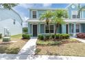 Inviting blue townhome with manicured landscaping and a paved walkway leading to the entrance at 11617 Colony Lake Dr, Tampa, FL 33635