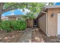 Inviting front entrance with stone walkway and established landscaping at 11816 Cedarfield Dr, Riverview, FL 33579