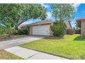 Attractive single-Gathering home with a well-maintained lawn and two-car garage at 11816 Cedarfield Dr, Riverview, FL 33579