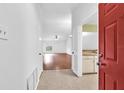 Bright entry view of living room and a glimpse of the kitchen at 11816 Cedarfield Dr, Riverview, FL 33579
