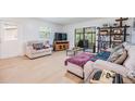 Bright living room with modern flooring, comfortable seating, and sliding doors to a screened patio at 1400 Tarpon Woods Blvd # E4, Palm Harbor, FL 34685