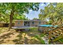 Expansive backyard with an above-ground pool, trampoline, and plenty of space for recreation at 1403 W Pradera Ave, Tampa, FL 33612