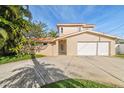Stunning two-story home with a red tile roof, a gated courtyard entry, and an attached two-car garage at 1427 40Th Ne Ave, St Petersburg, FL 33703