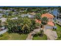 Beautiful home with mature landscaping, a circular driveway, and a terracotta colored roof in a waterfront community at 1427 40Th Ne Ave, St Petersburg, FL 33703