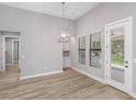 Bright dining area with stylish light fixture and large windows at 17404 Nokota Ave, Hudson, FL 34667