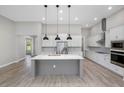 Modern kitchen with white cabinets, stainless steel appliances, and a large center island at 17404 Nokota Ave, Hudson, FL 34667