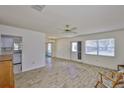 Bright living room features neutral walls, wood-look flooring, and a ceiling fan, creating a welcoming space at 1904 Canterbury Ln # 18, Sun City Center, FL 33573