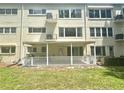 Rear view of the condo building with covered patio and well-maintained yard at 2262 Swedish Dr # 6, Clearwater, FL 33763