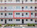 Exterior of a well-maintained condo building featuring a clean white facade and multiple units with private balconies at 3114 59Th S St # 203, Gulfport, FL 33707