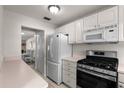 Charming kitchen with white cabinets, stainless steel appliances, and ample counter space, perfect for cooking enthusiasts at 3114 59Th S St # 203, Gulfport, FL 33707