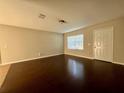 Open living area with hardwood floors, a front door, and neutral wall colors at 404 Water St, Plant City, FL 33563