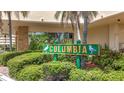 The Columbia Condo community sign is surrounded by lush landscaping at 4725 Cove Circle # 908, St Petersburg, FL 33708