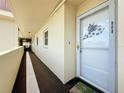 Exterior hallway with carpet and unit front door 908 at 4725 Cove Circle # 908, St Petersburg, FL 33708