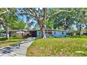 A charming home nestled among mature trees, offering a serene and inviting curb appeal at 6700 14Th N St, St Petersburg, FL 33702