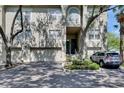 Inviting two-story condo exterior with attached garages, manicured landscaping, and private entrance at 746 Coral Reef Dr # 746, Tampa, FL 33602