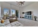 Bright living room with modern furnishings, neutral carpet, and sliding doors to private balcony at 746 Coral Reef Dr # 746, Tampa, FL 33602