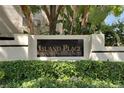 Elegant community sign reading 'Island Place Private Residences' surrounded by lush greenery at 746 Coral Reef Dr # 746, Tampa, FL 33602