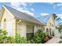 A close-up view of the home showcasing a charming exterior, beautiful landscaping, and well-placed windows at 7833 Ontario Street Cir, Sarasota, FL 34243