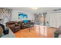 Bright living room featuring wood floors, sliding glass doors, and modern decor at 802 Antler Ct, Brandon, FL 33511