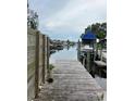 Beautiful waterfront view from a wooden dock showcasing a calm canal and boats at 802 White Heron Blvd, Ruskin, FL 33570